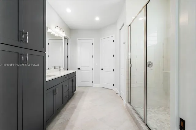 a large bathroom with a double vanity sink and mirror