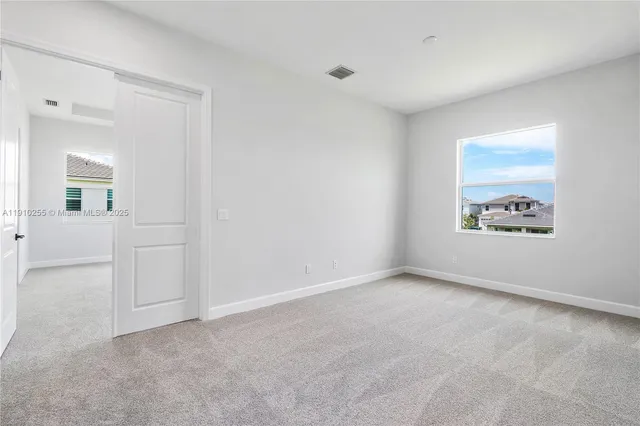 an empty room with windows and entrance