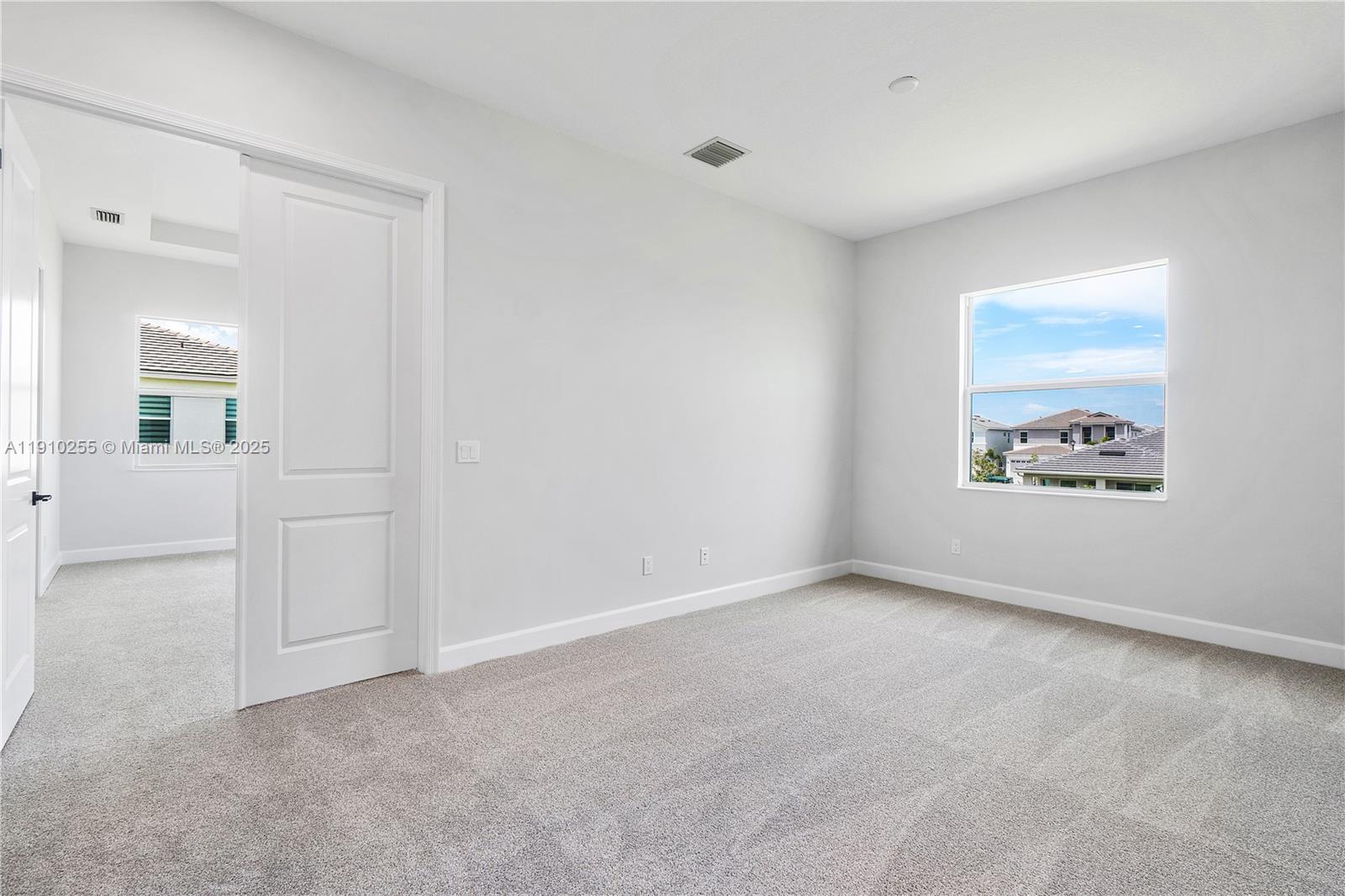 5488 Liberty Lane, Unit 5488 Westlake, FL 33470 - Photo 25 of 39 an empty room with windows and entrance