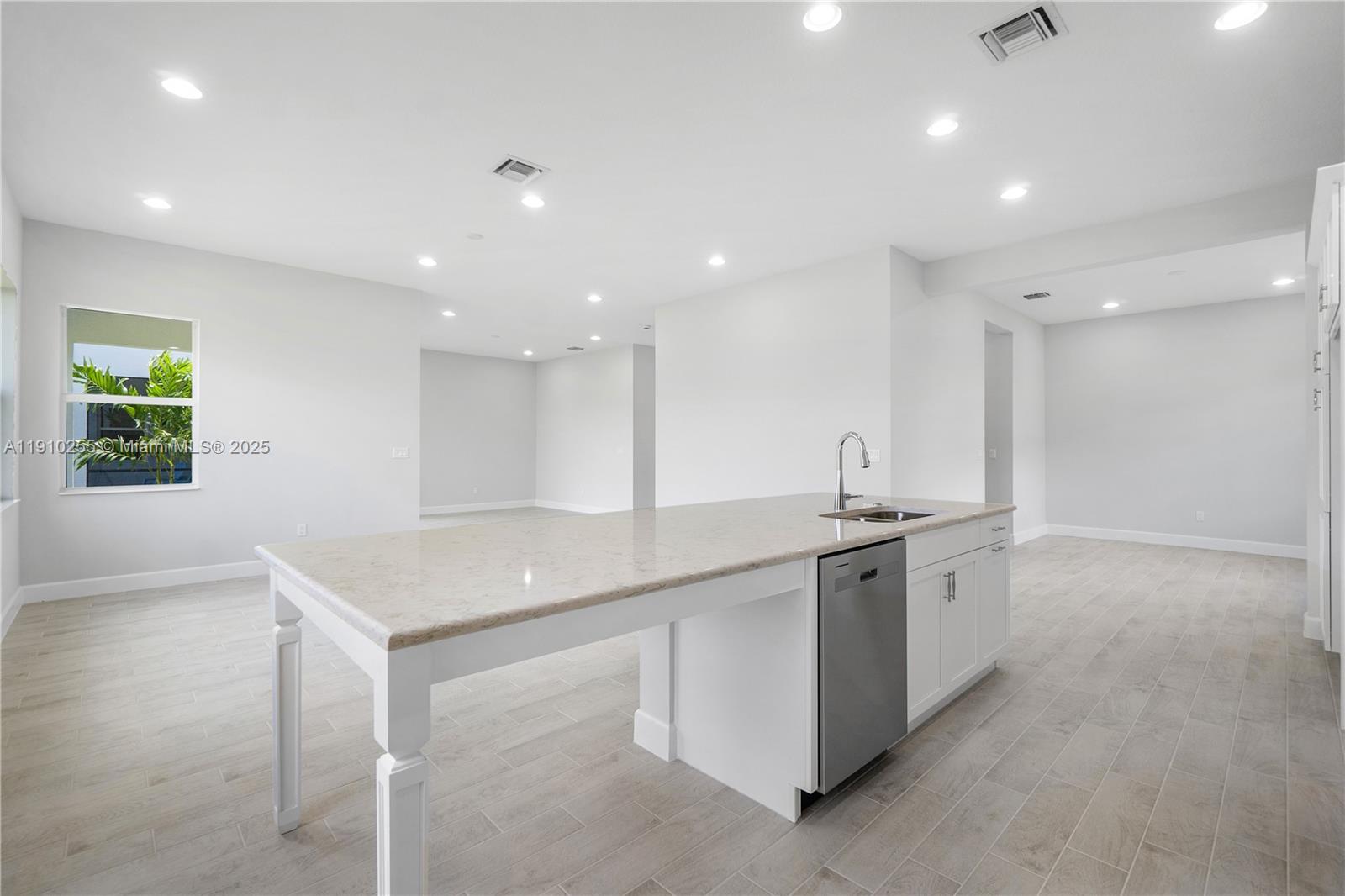 5488 Liberty Lane, Unit 5488 Westlake, FL 33470 - Photo 29 of 39 a kitchen with stainless steel appliances granite countertop a sink and a stove top oven with wooden floor