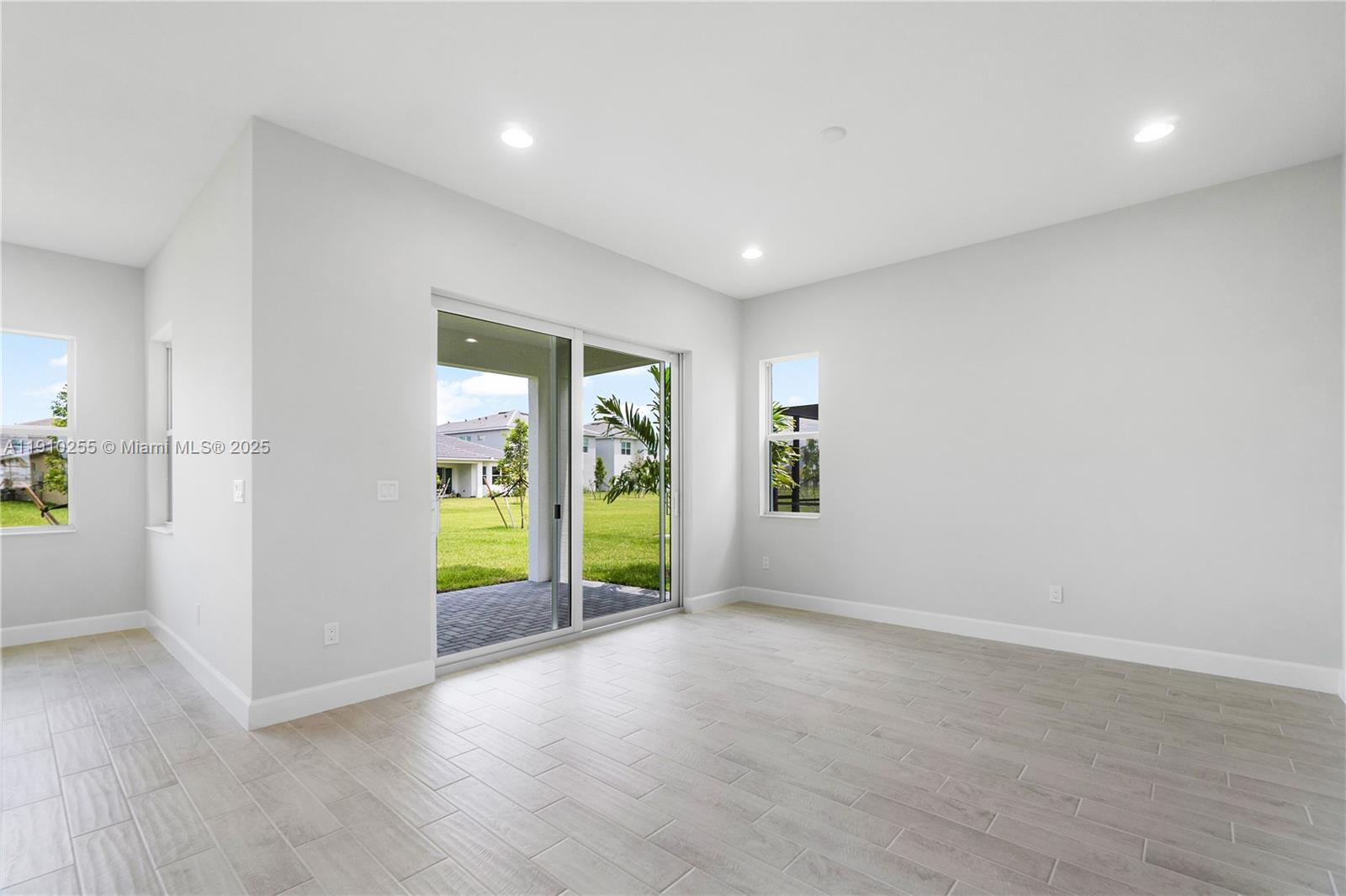 5488 Liberty Lane, Unit 5488 Westlake, FL 33470 - Photo 34 of 39 wooden floor in an empty room with a window