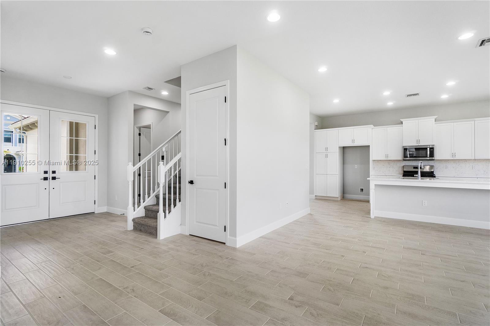 5488 Liberty Lane, Unit 5488 Westlake, FL 33470 - Photo 35 of 39 a view of a kitchen with a sink and dishwasher a refrigerator with wooden floor