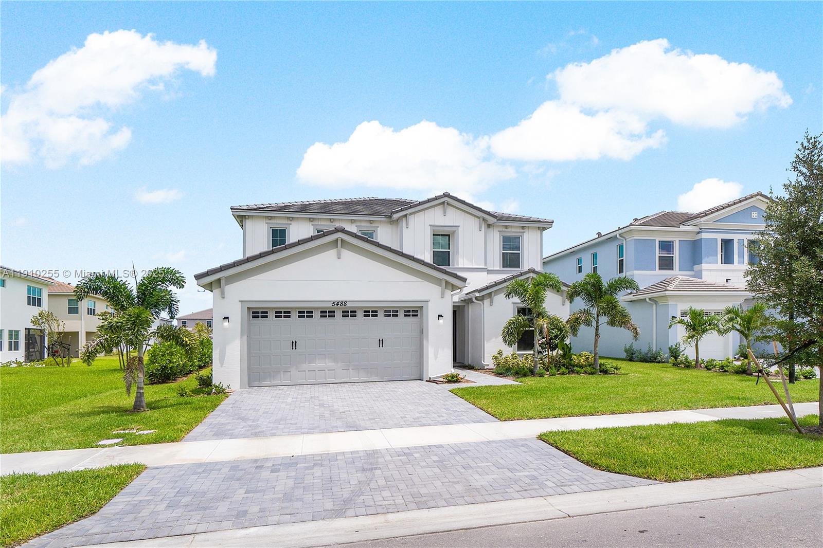 5488 Liberty Lane, Unit 5488 Westlake, FL 33470 - Photo 37 of 39 a front view of a house with a yard