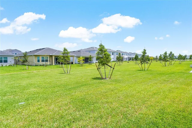 a view of a big yard with a swimming pool