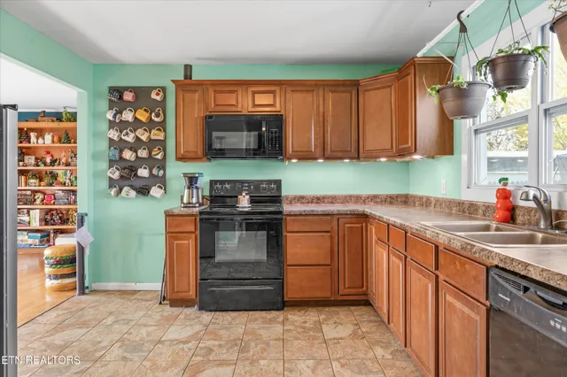 a kitchen with stainless steel appliances granite countertop a sink and a stove top oven