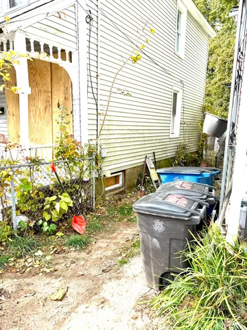 a view of a house with a backyard and sitting area