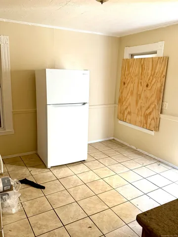 a view of a room with a door and a window