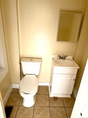 a bathroom with a toilet and a mirror