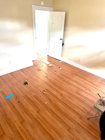 an empty room with wooden floor