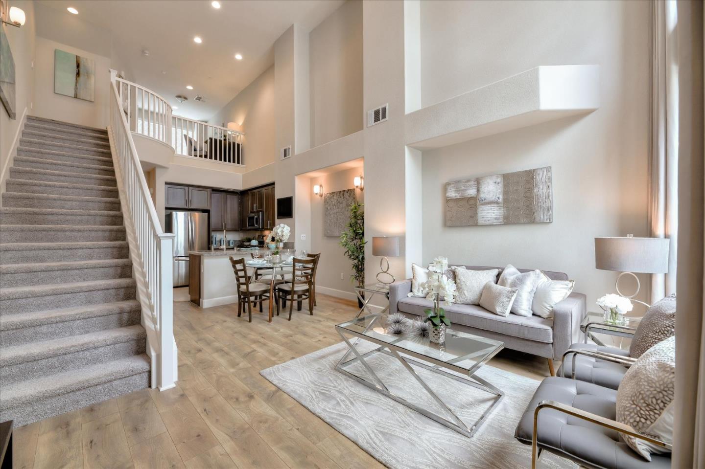131 Hudson Place San Jose, CA 95123 - Photo 4 of 16 a living room with furniture and a dining table with chandelier