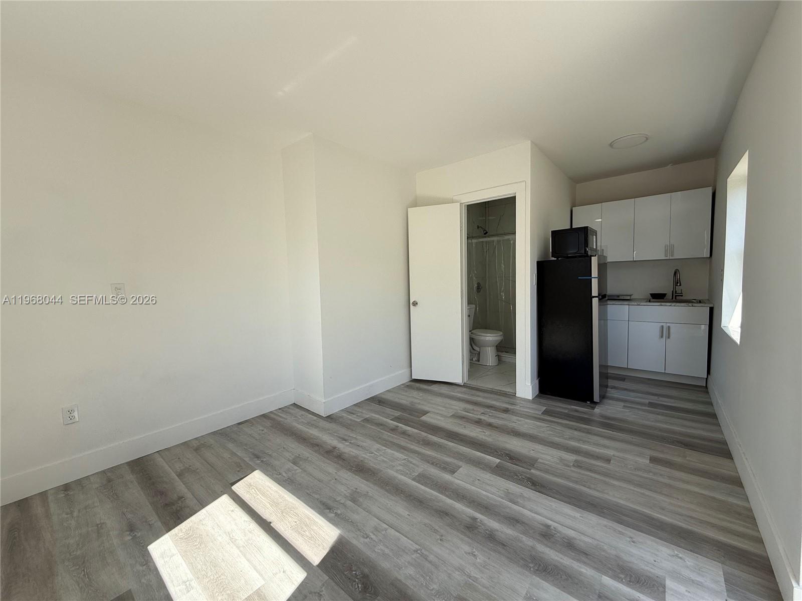 2801 Southwest 26th Street, Unit RLEFT Miami, FL 33133 - Photo 4 of 10 a view of empty room with wooden floor