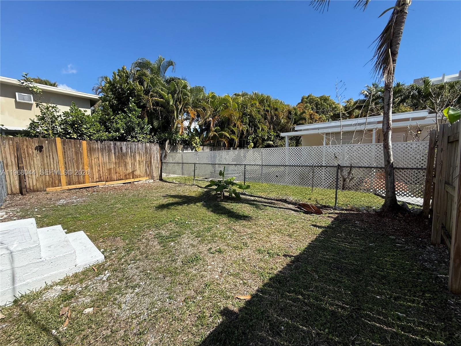 2801 Southwest 26th Street, Unit RLEFT Miami, FL 33133 - Photo 9 of 10 a backyard of a house with lots of green space