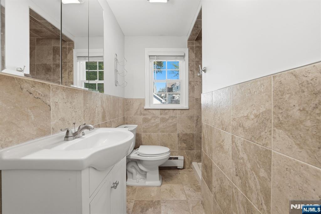 44 Alpine Place Kearny, NJ 07032 - Photo 40 of 50 a bathroom with a sink a toilet and shower