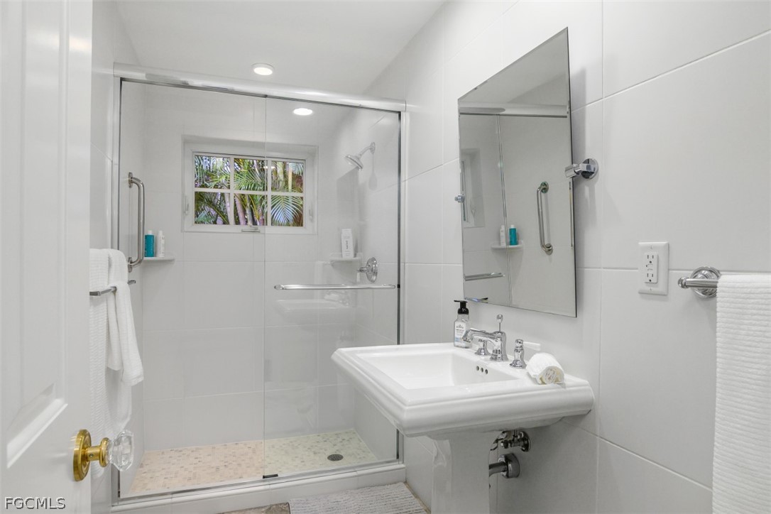 549 7th Avenue North Naples, FL 34102 - Photo 14 of 19 a bathroom with a sink a toilet and shower