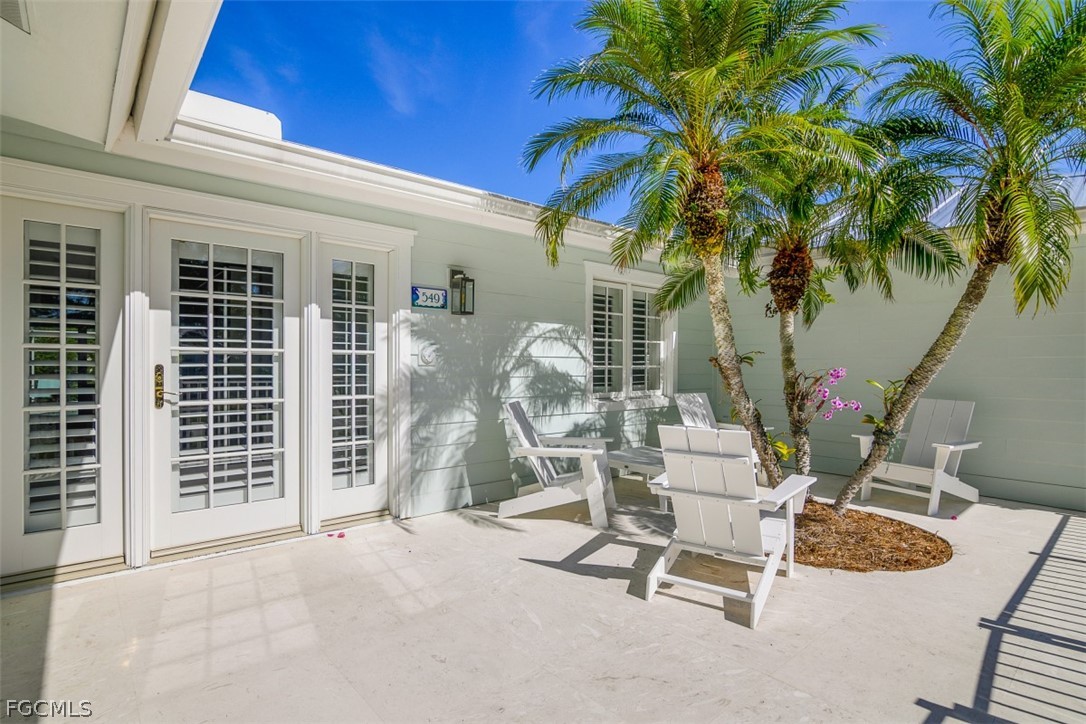 549 7th Avenue North Naples, FL 34102 - Photo 2 of 19 a view of a chairs and table in patio