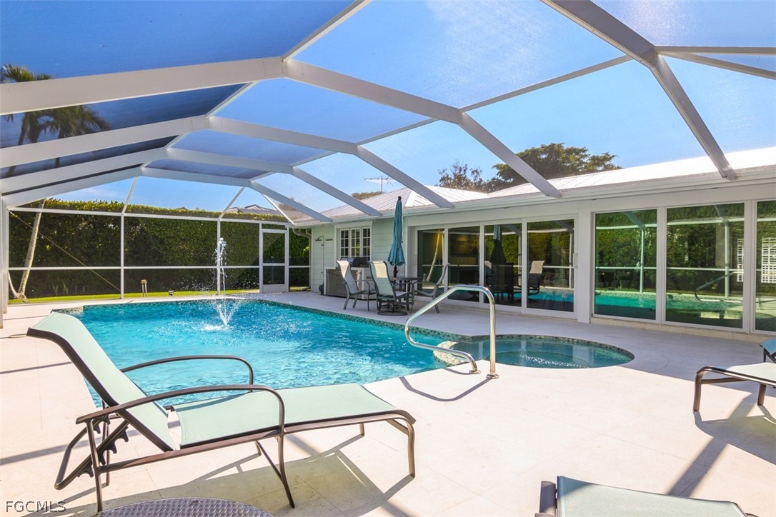 549 7th Avenue North Naples, FL 34102 - Photo 5 of 19 a view of a patio with a table and chairs