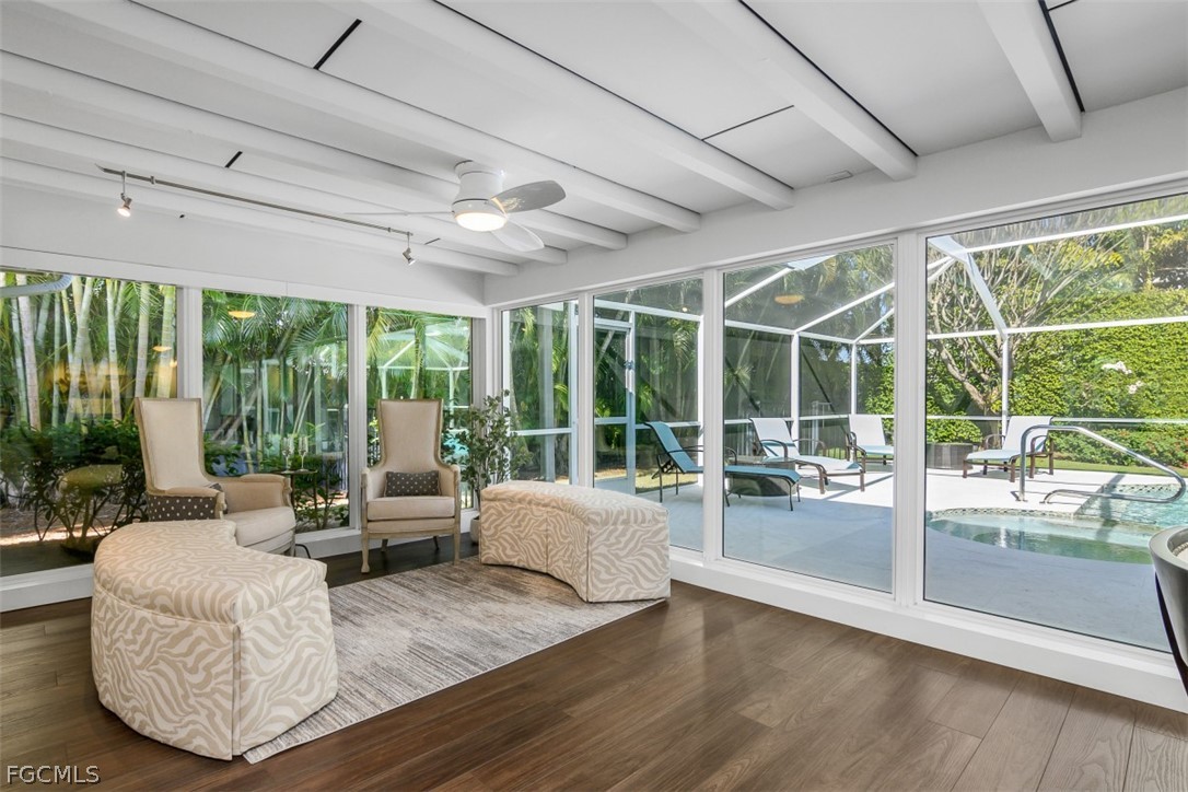 549 7th Avenue North Naples, FL 34102 - Photo 7 of 19 a living room with furniture large windows and wooden floor