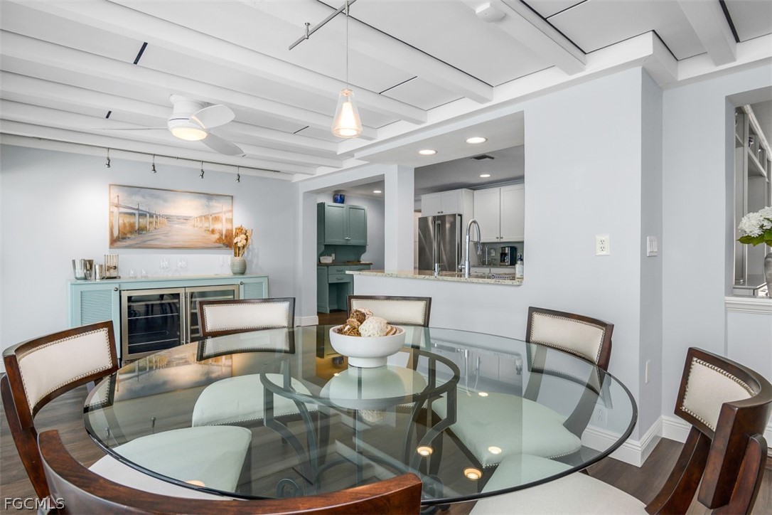 549 7th Avenue North Naples, FL 34102 - Photo 8 of 19 a dining room with furniture a floor to ceiling window and wooden floor