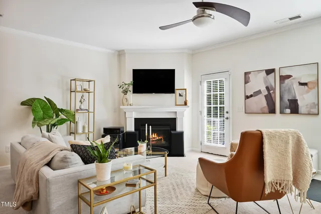 a living room with furniture a fireplace and a flat screen tv