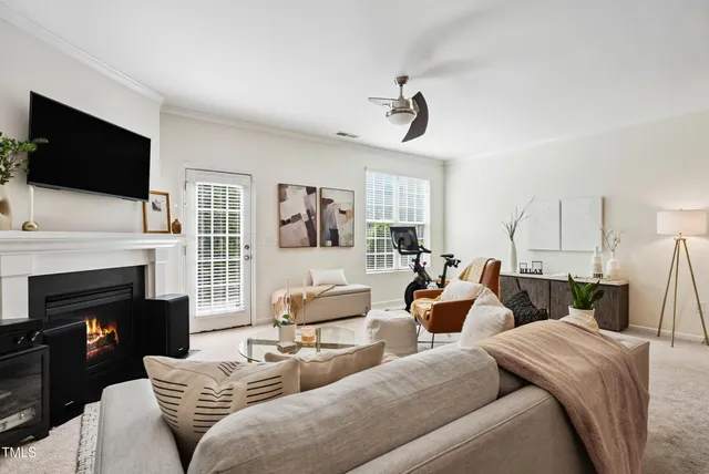 a living room with furniture a fireplace and a flat screen tv