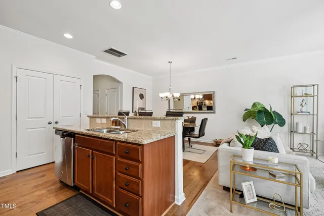 a kitchen with stainless steel appliances granite countertop a sink and a refrigerator