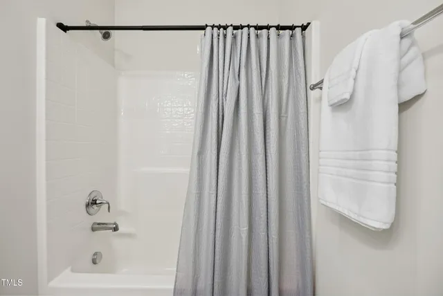 a bathroom with a shower and a tub