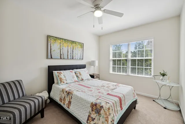 a bedroom with a bed couch and window