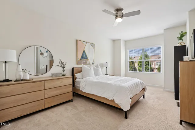 a bed sitting in a bedroom next to a window