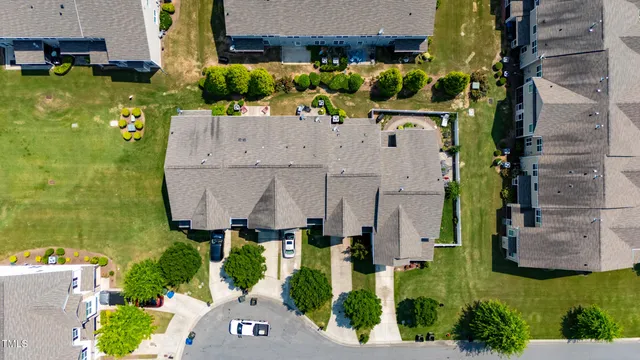 an aerial view of a house with a garden and yard