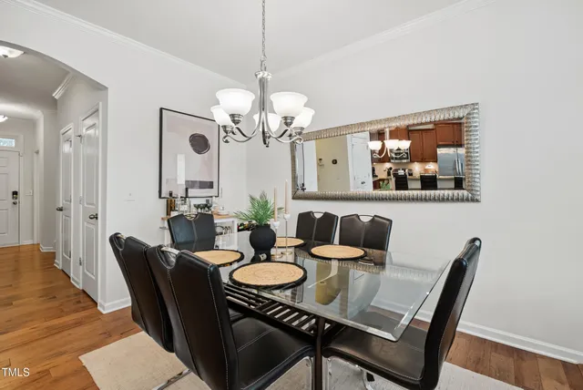 a view of a dining room with furniture wooden floor and a chandelier