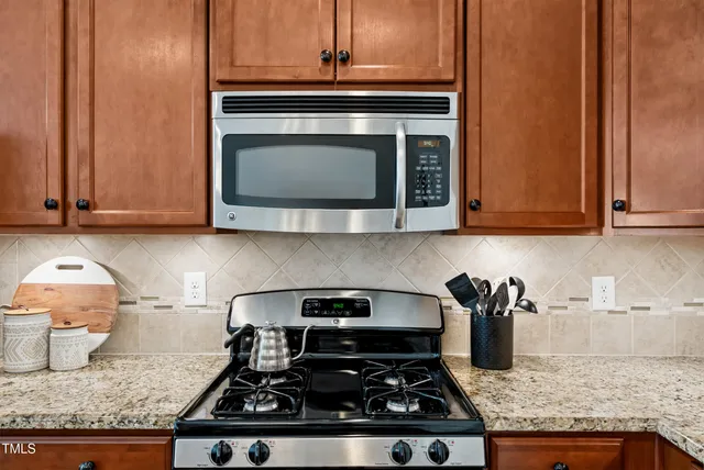a kitchen with granite countertop a stove and a sink