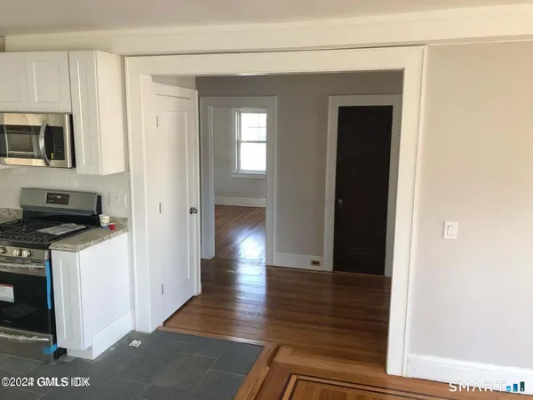 a view of a kitchen from the hallway