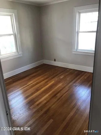 an empty room with wooden floor