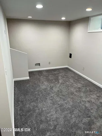 a white toilet sitting next to a bath tub
