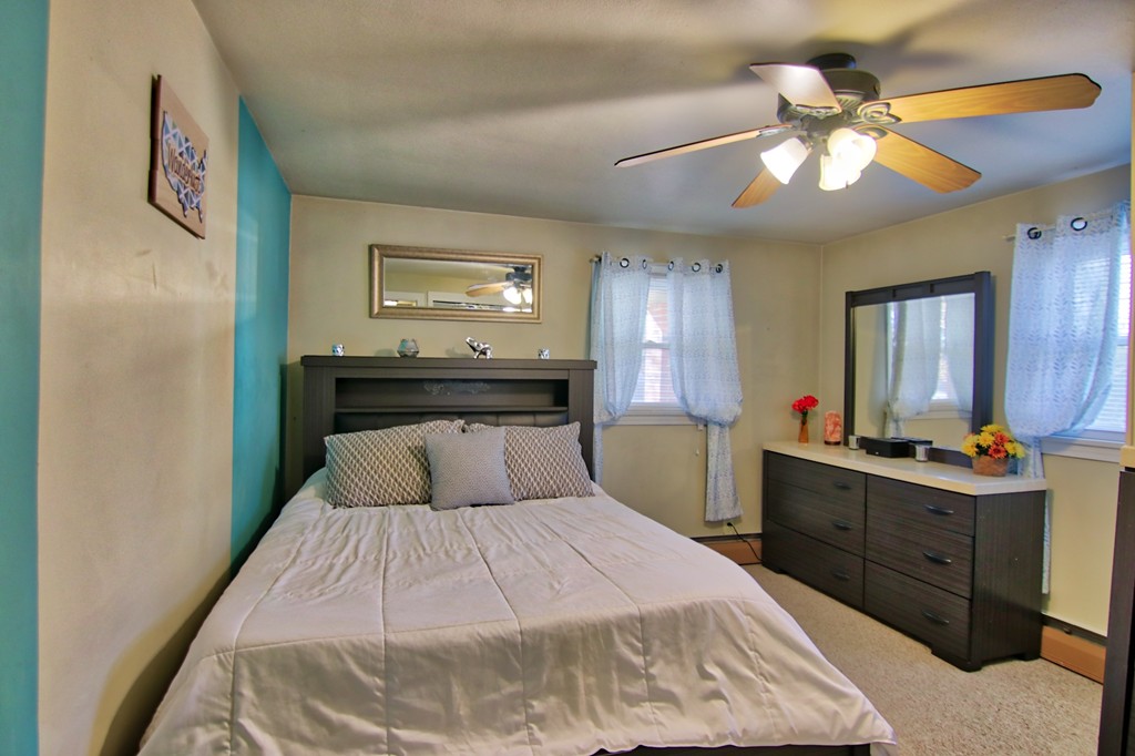 114 Huron Street Springfield, MA 01104 - Photo 10 of 22 a bedroom with a bed and a chandelier