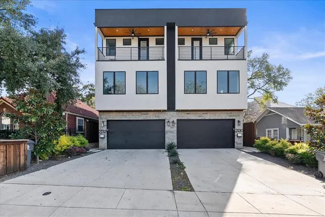 front view of a brick house with a yard