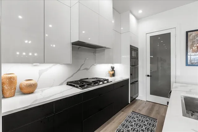a kitchen with counter top space and stainless steel appliances