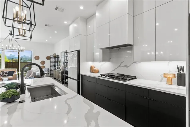 a kitchen with stainless steel appliances kitchen island granite countertop a stove a sink and a refrigerator