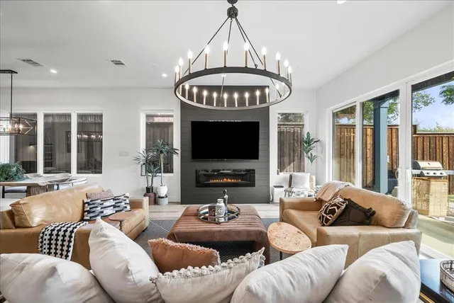 a living room with furniture a couch and a chandelier