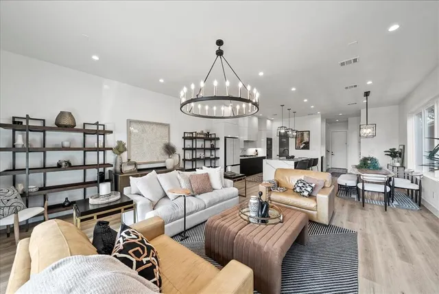 a kitchen with stainless steel appliances granite countertop a refrigerator and a stove