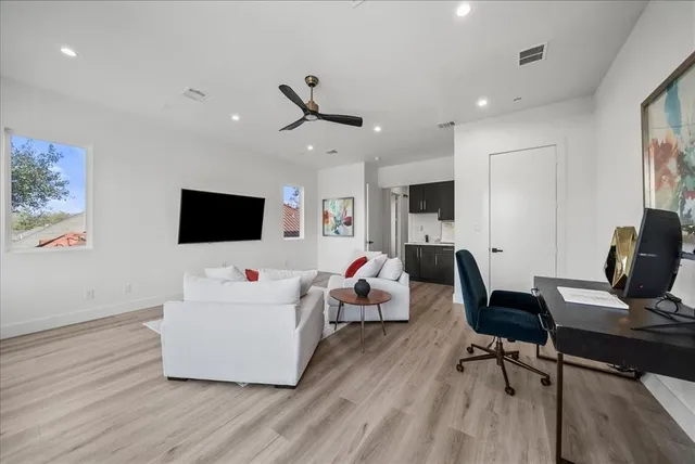 a bedroom with a bed and a flat tv screen on dresser