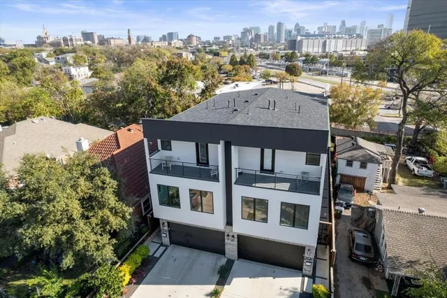 a kitchen with stainless steel appliances granite countertop a stove a sink dishwasher and a dining table with wooden floor