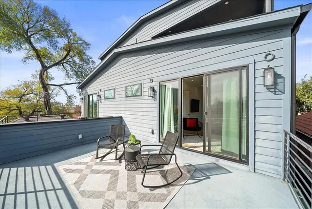 a bedroom with a large bed chandelier and a window