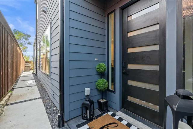 a kitchen with stainless steel appliances kitchen island a table and chairs in it