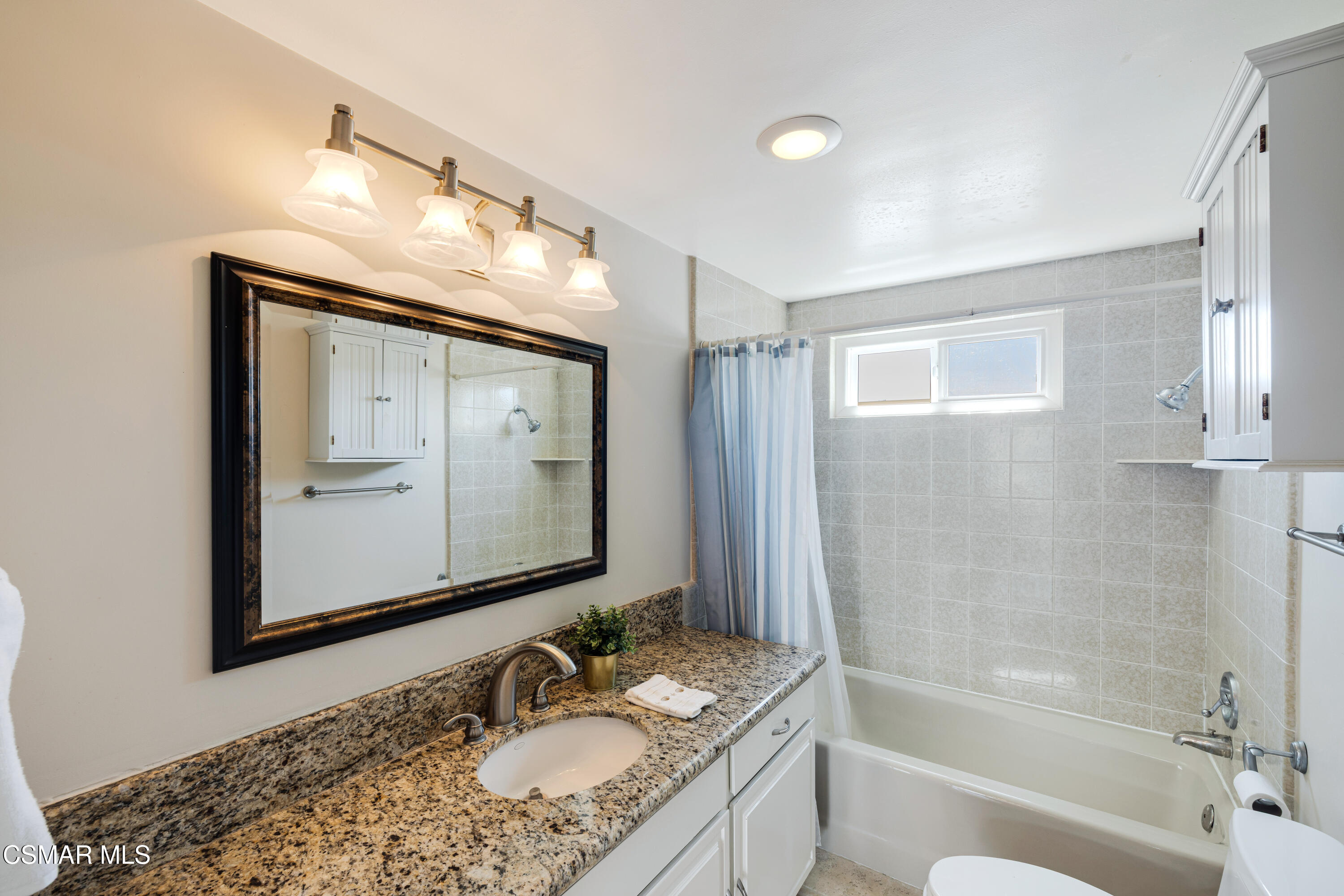 108 Pasadena Avenue Oxnard, CA 93035 - Photo 13 of 29 a bathroom with a granite countertop sink mirror and a bathtub