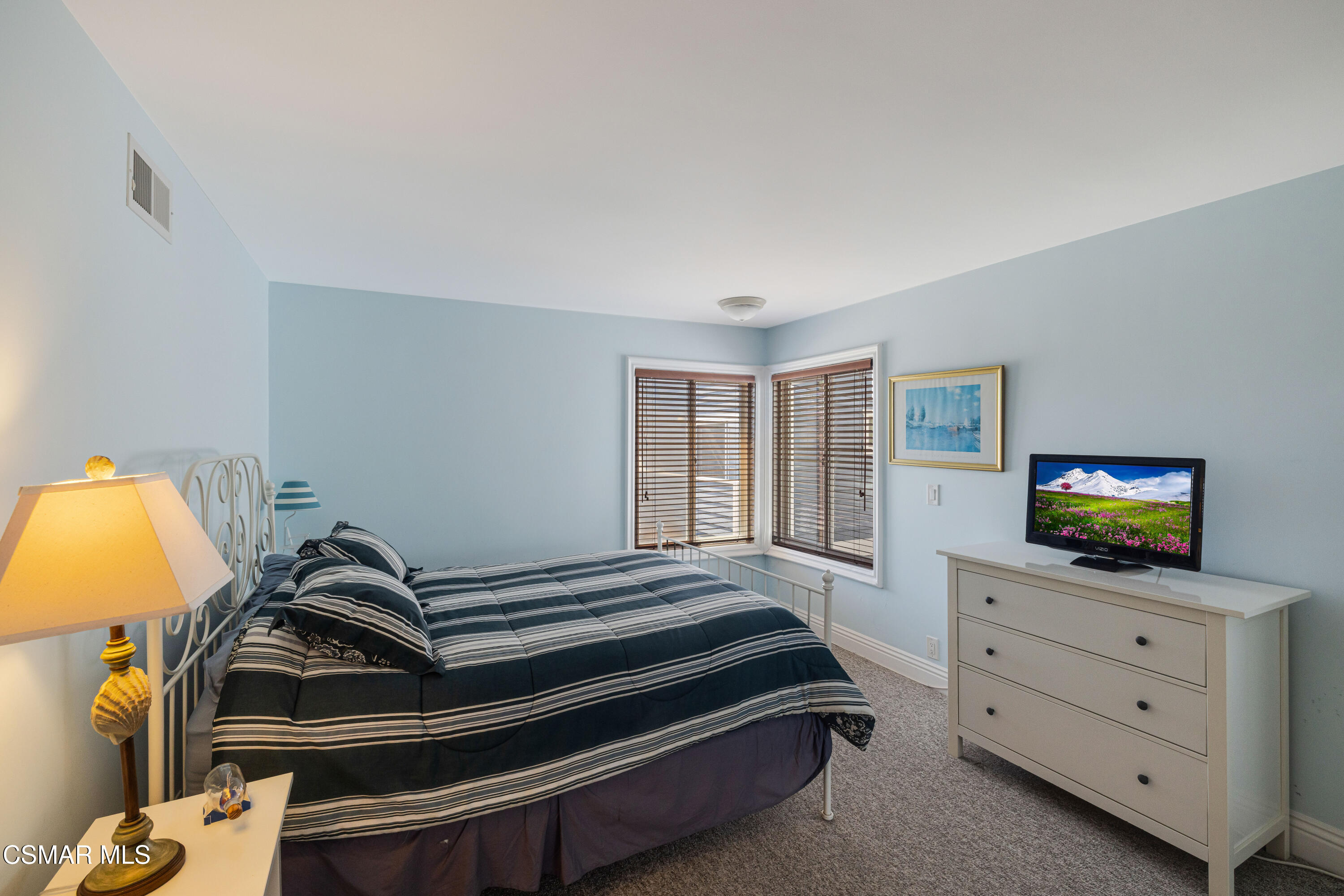 108 Pasadena Avenue Oxnard, CA 93035 - Photo 14 of 29 a bedroom with a bed and a flat tv screen on the dresser