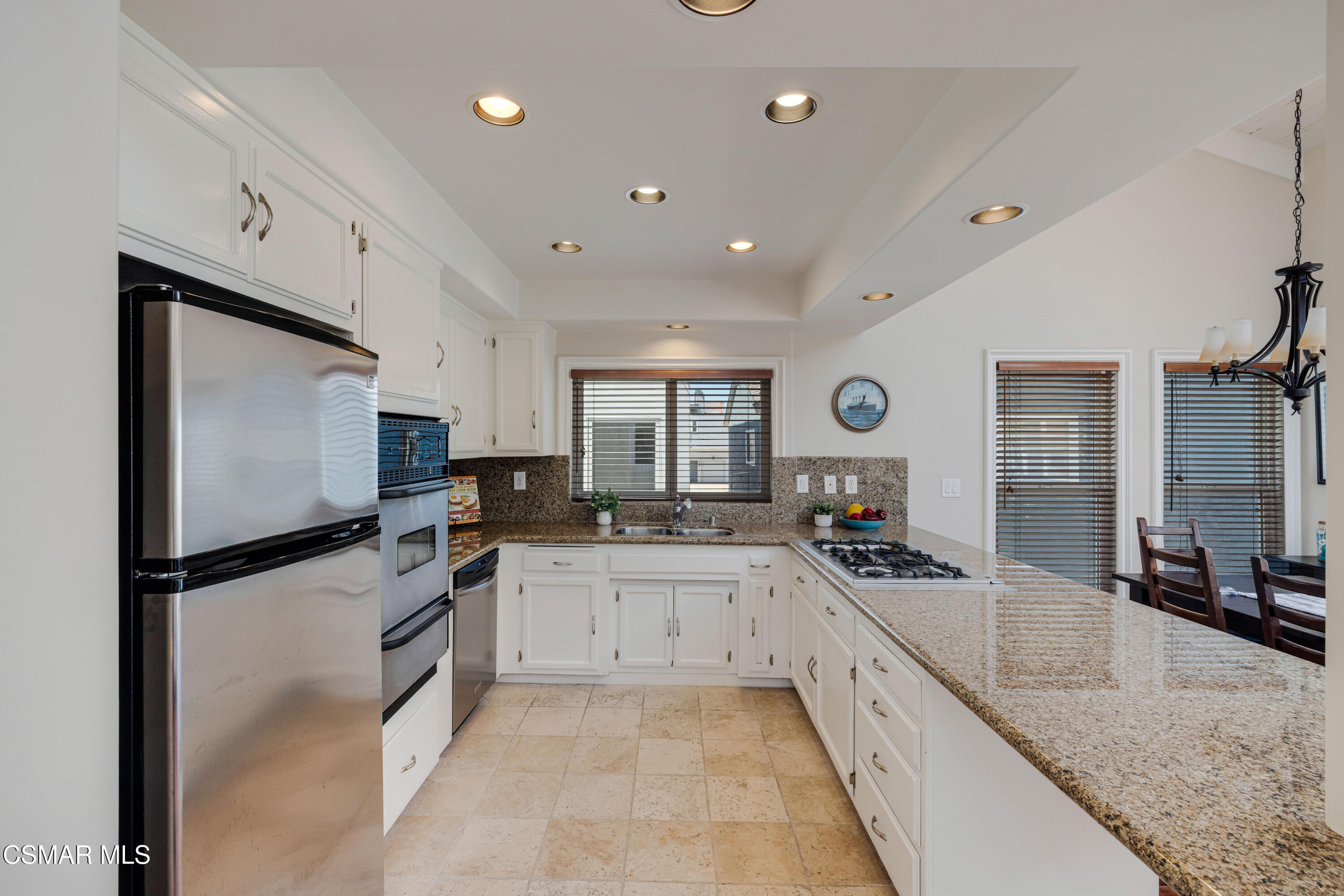 108 Pasadena Avenue Oxnard, CA 93035 - Photo 4 of 29 a large kitchen with granite countertop a large counter top stainless steel appliances and cabinets