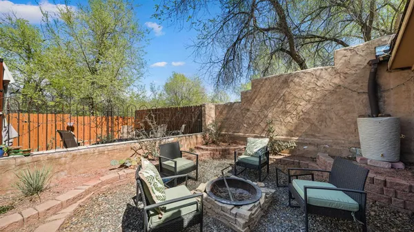 a view of backyard with outdoor seating and trees