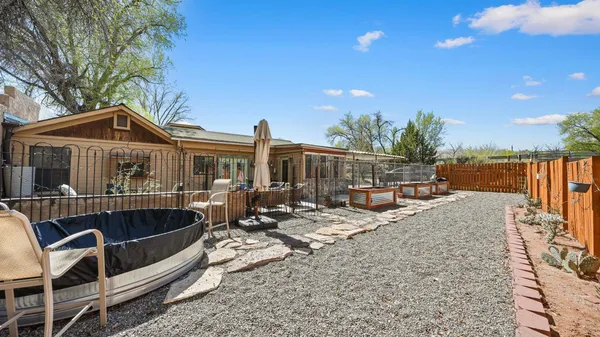 a view of a house with swimming pool and sitting area