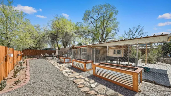 a backyard of a house with barbeque oven table and chairs